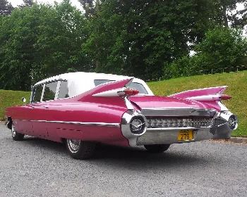 Rear view of a pink classic Cadillac with iconic tailfins