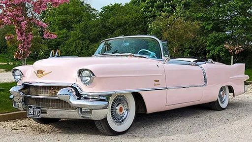 Classic American Cadillac wedding car in Pink with convertible roof open