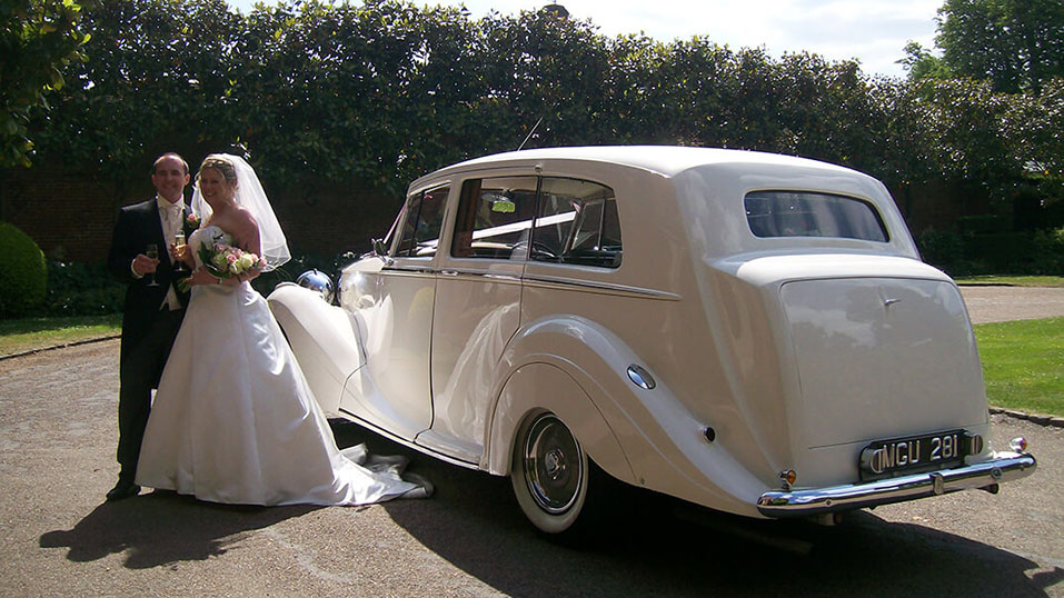 rear 3/4 view of the white vintage rolls-royce