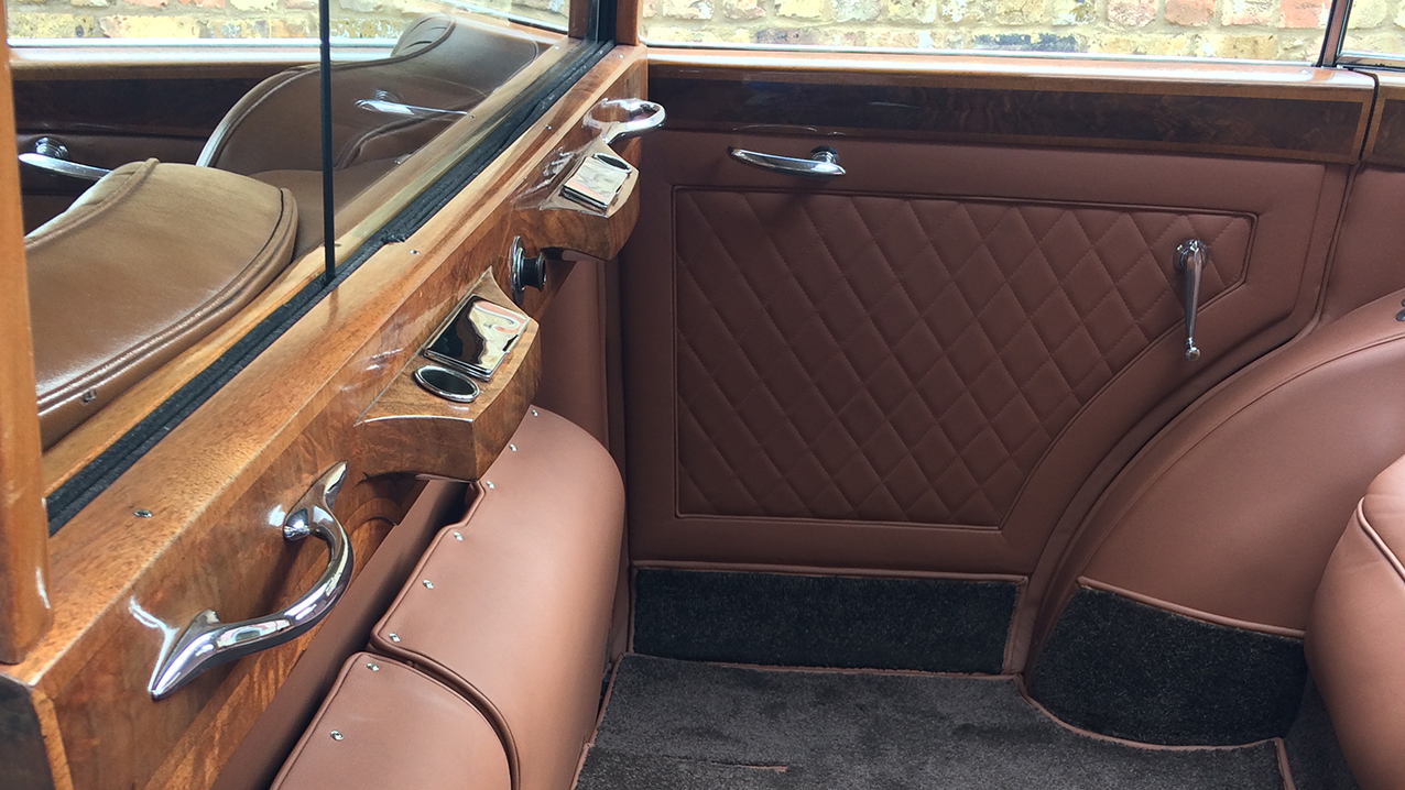 rear cabin of vintage rolls-royce showing the casual seats up