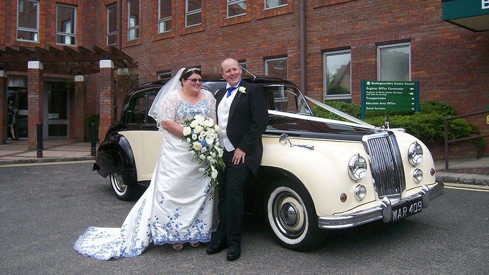 Armstrong-Siddeley Limousine with couple in front of the vehicle