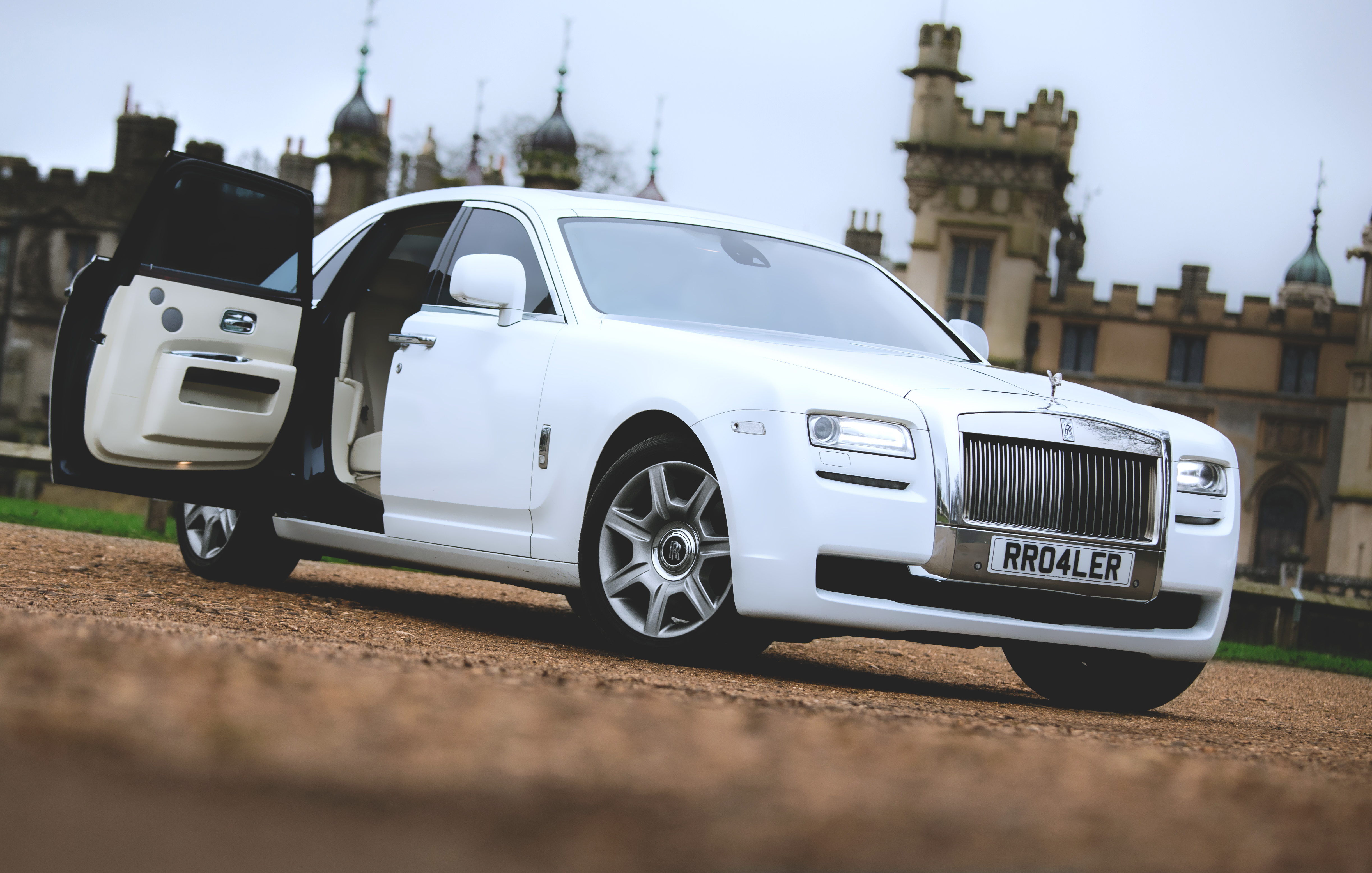 White Rolls-Royce Ghost with the Door Open showing a Cream Leather interior
