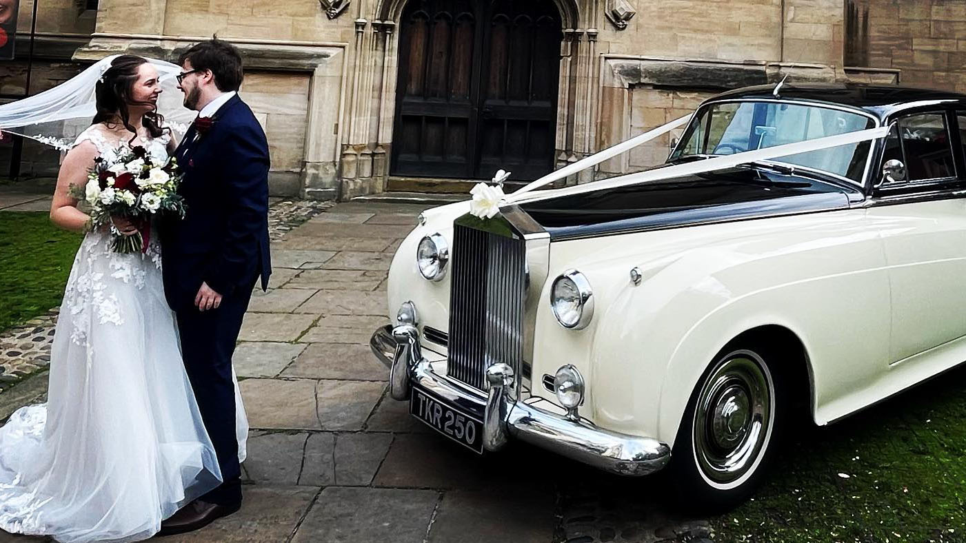 Bride and Groom having photos taken in front of their classic rolls-royce in Doncaster