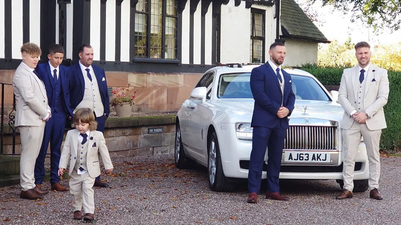 Groom and his best men posing for photos with their White Rolls-Royce before being taken to their wedding Ceremony