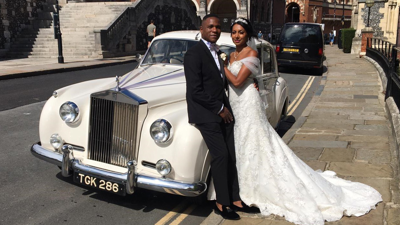 Couple posing in front of the classic rolls-royce