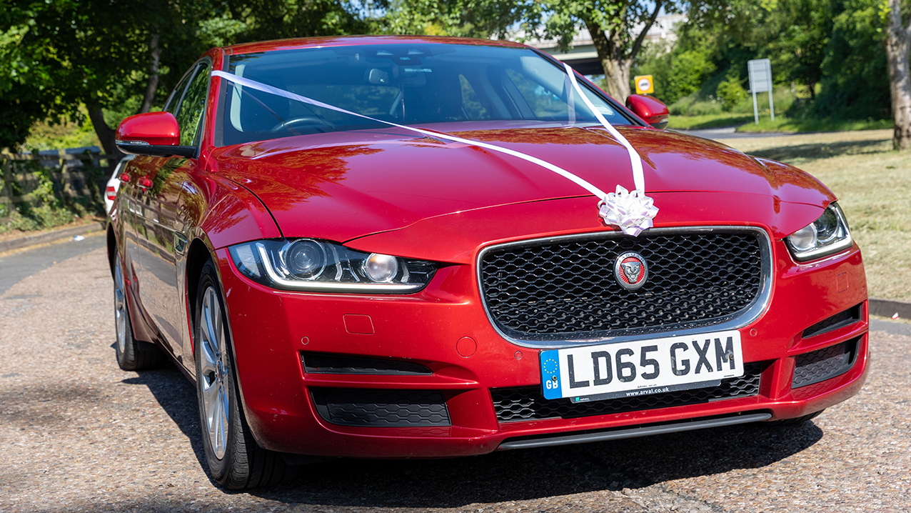 Modern REd Jaguar 3/4 view with White Wedding ribbons