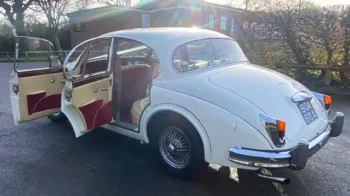 Left Rear Side View with both doors open showing the cream leather interior