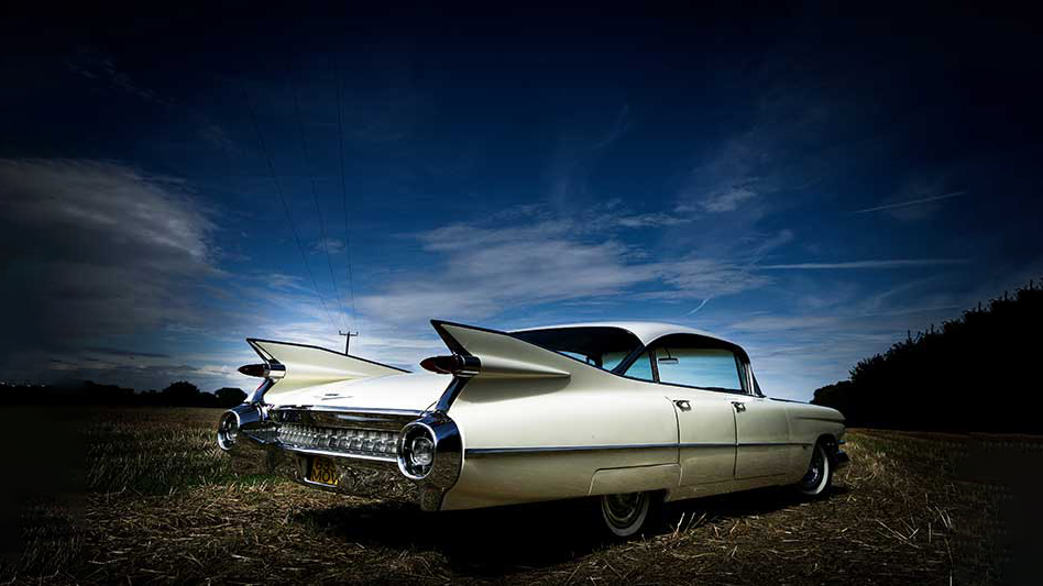 rear view of an ivory cadillac showing chrome bumper