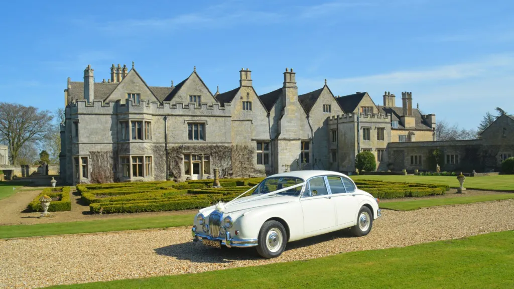 White Daimler 250 V8 dressed with traditional white Wedding Ribbon.