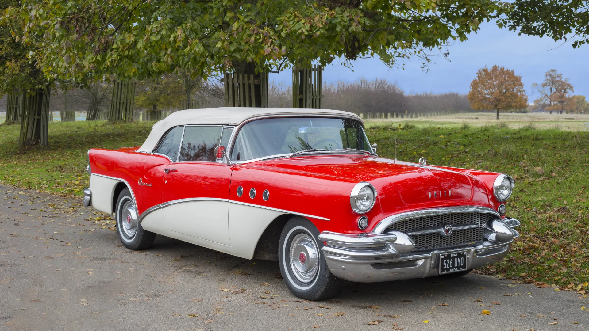 White and Red Classic Buick in front of wedding venue
