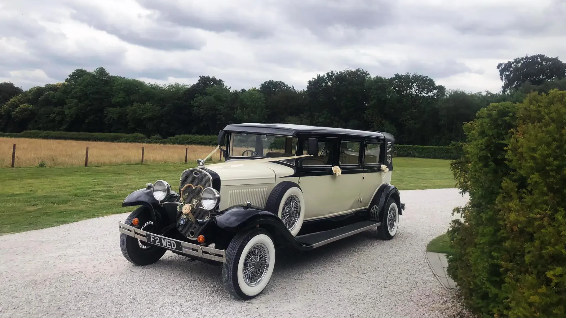 Black & ivory Vintage Bramwith entering wedding venue
