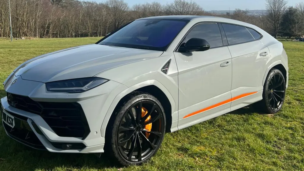 White Lamborghini Urus in a field