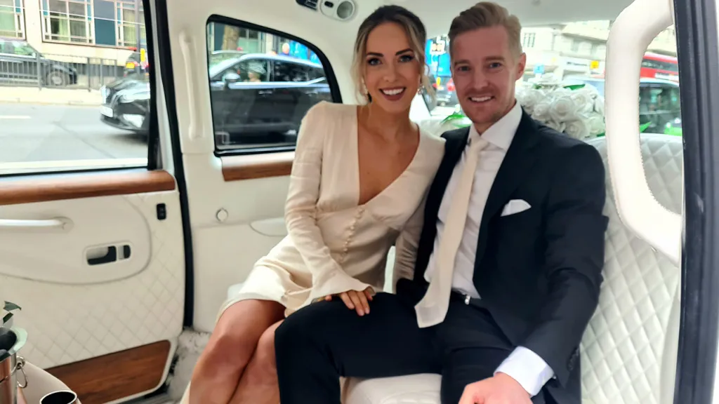 Bride and Groom inside Modern Taxi Cab with Cream Leather interior