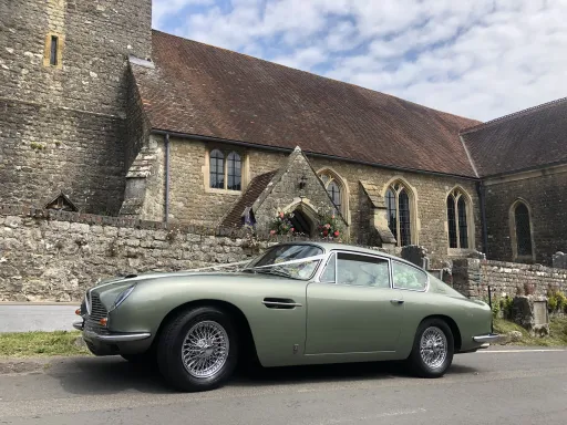 Metallic Green Classic aston Martin DB6 in front of church