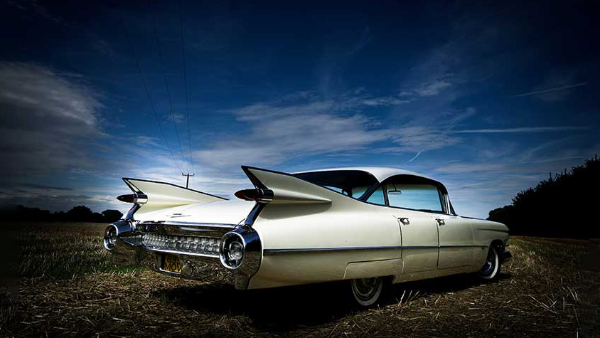 Rear view of Ivory White Cadillac showing the fine tail and wealth of Chrome on its bumper
