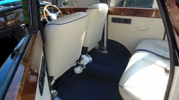 Rear interior seating area of Convertible Royale ;whowing Royale Blue Carpet and Cream Leather Seat with plenty of leg room