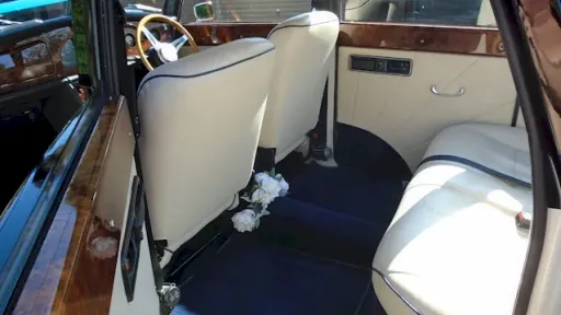 Rear interior seating area of Convertible Royale ;whowing Royale Blue Carpet and Cream Leather Seat with plenty of leg room