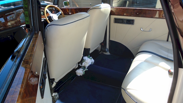 Rear interior seating area of Convertible Royale ;whowing Royale Blue Carpet and Cream Leather Seat with plenty of leg room