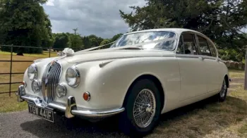 Front Left Side View of White Mk2 Jaguar dressed with White Ribbons accross its bonnet and spokes alloy wheels