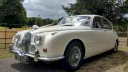 Front Left Side View of White Mk2 Jaguar dressed with White Ribbons accross its bonnet and spokes alloy wheels