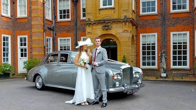 Two Tone Silver Bentley S3 with Bride and Groom standing in front of the vehicle