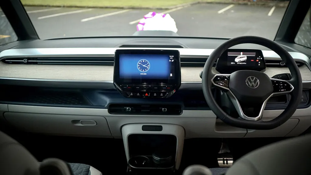Inside photo of the front of the vehicle showing the dashbord of an electric VW ID Buzz Campervan.