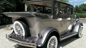 Side Rear view of Silver imperial with roof open showing the white wheels and the rear mounted fifth wheel