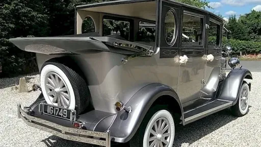 Side Rear view of Silver imperial with roof open showing the white wheels and the rear mounted fifth wheel
