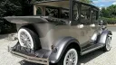 Side Rear view of Silver imperial with roof open showing the white wheels and the rear mounted fifth wheel