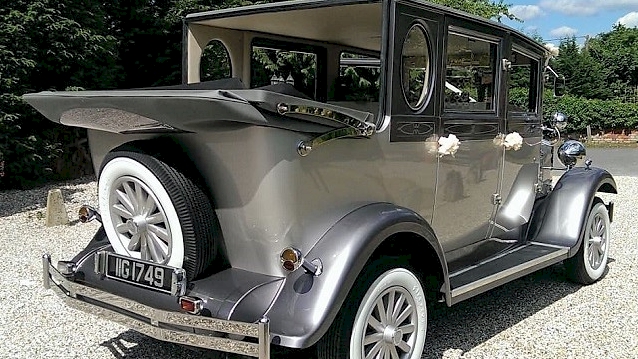 Side Rear view of Silver imperial with roof open showing the white wheels and the rear mounted fifth wheel