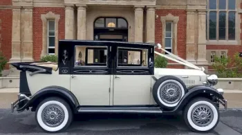 Righ Side view of vintage imperial car with white ribbons. While wall ties and spokes wheels