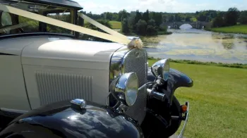 front view of vintage bramwith dressed with Ivory ribbons, black wheel arches and chrome grill and headlights