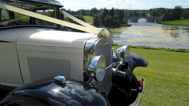 front view of vintage bramwith dressed with Ivory ribbons, black wheel arches and chrome grill and headlights