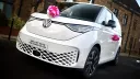 Front side view of Electric VW Campervan decorated with Pink bow