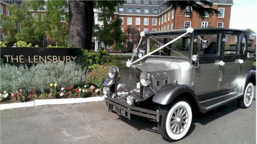 Side view of Imperial decorated with White ribbon. Car has light silver on its body and darker silver grey on top half