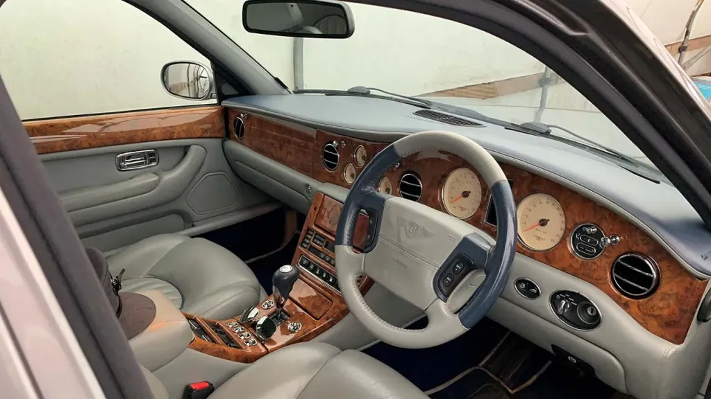 Inside Driver Seat showing cream leather interior and light wooden dashboard