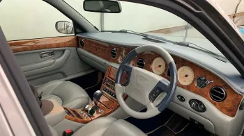 Inside Driver Seat showing cream leather interior and light wooden dashboard