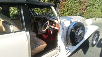 Close up side view with Chauffeur's door pen shwoing the cream leather seats and wooden dashboard