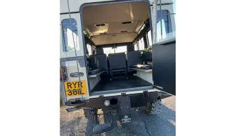 Rear of Classic land Rover showing large open door access for wedding guests