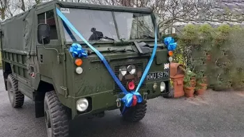 Front side view of a Army Khaki green decorated with royale Blue ribbons