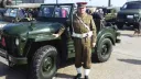 Chaufeur in a Ceremonial Period uniform in front of Army Green Classic austin Champ