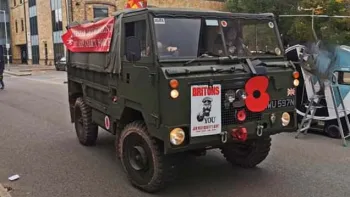 Front view of Classic austin Champ decorated with white wedding ribbons and UK flag  at rear of the vehicle