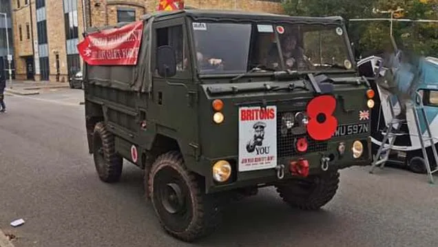 Front view of Classic austin Champ decorated with white wedding ribbons and UK flag  at rear of the vehicle