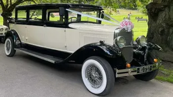 Front Side View of an Ivory Vintage Bramwith with Black Wheel Arches and white wall tires
