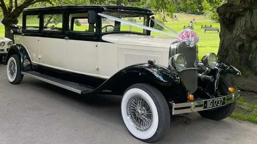 Front Side View of an Ivory Vintage Bramwith with Black Wheel Arches and white wall tires