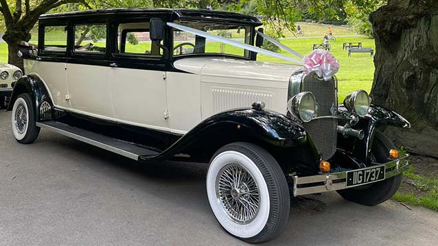 Front Side View of an Ivory Vintage Bramwith with Black Wheel Arches and white wall tires