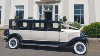 right Side view of Ivory Bramwith with Black wheel arches and black roof, white wall tires and white V-shape ribbon accroos the bonnet