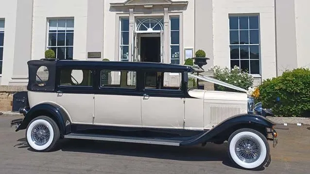 right Side view of Ivory Bramwith with Black wheel arches and black roof, white wall tires and white V-shape ribbon accroos the bonnet