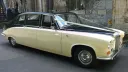 Right Side view of ivory Daimler with Black roof decorated with Light pink Wedding ribbons