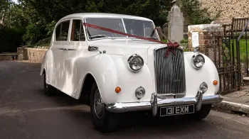 Front side view of Ivory Classic Austin Princess decorated with Burgundy Ribbons